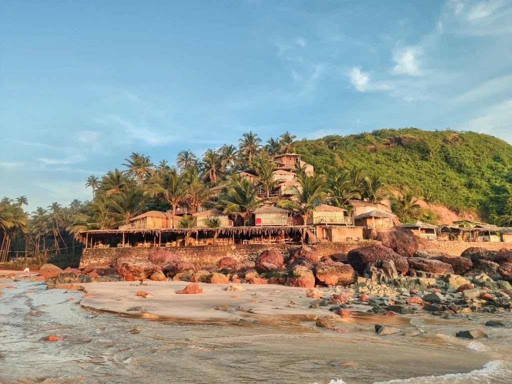Eco cottages built on the hillside stepping down to the shore at Cola Beach