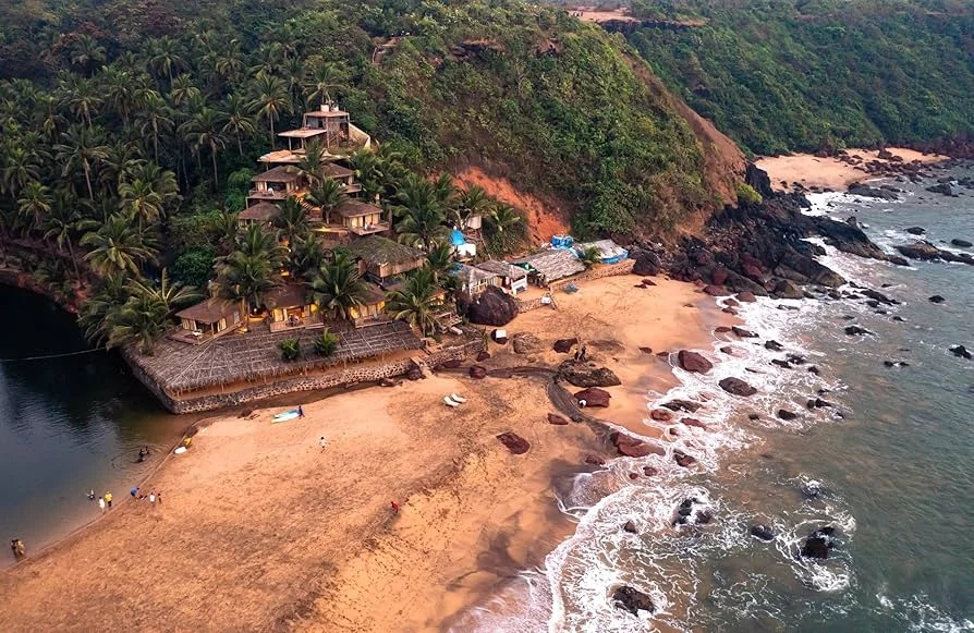 Beautiful aerial view of Cola Beach showing the calm freshwater lagoon running parallel to the blue sea