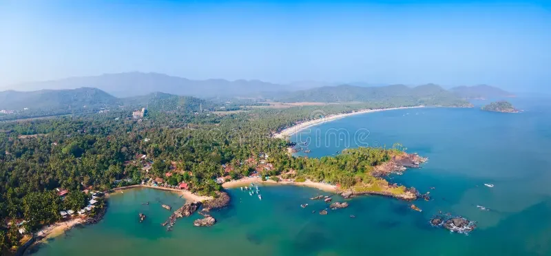 Stunning panoramic drone view of Colomb Bay and Palolem Beach coastline framed by lush green hills